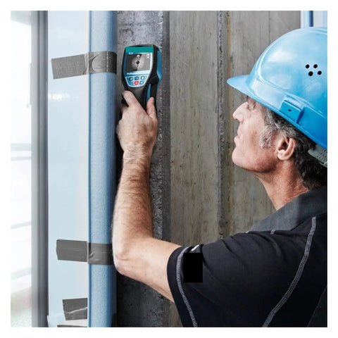 Heavy Duty Digital Wall Scanner Finds Studs Pipes And Cables With No Sweat dual battery tool in a worker's hand near a wall.