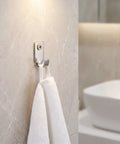 Heavy Duty Stainless Steel Picture Wall Mount Hooks Corrosion Resistant Drywall Brackets Built Like A Tank Worry Free Hanging For Big Frames And Mirrors Foolproof Install Design holding a white towel on a light marble wall.