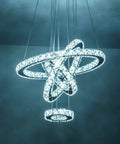 Dope Four Ring Crystal LED Chandelier With Adjustable Pendant Light In Chrome 6000K Cool White Bright Yet Soft Perfect For Living Room Dining Room And Bedroom Luxury Contemporary Ceiling Fixture showing illuminated crystal rings against dark ceiling