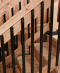 Rectangular Baluster One Inch By Half Inch, Thirty Two Inch Long, Built Tough Heavy Gauge Galvanized Steel With Powder Coated Black Finish, Thermally Bonded Glossy Surface, Set Of 10 For Railings And Stairs installed on wooden staircase.