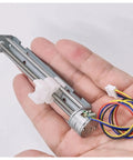 Person holding a DIY Friendly Two-Phase Four-Wire Stepper Motor Kit with 5V to 9V input, featuring 15mm drive, 80mm linear actuator.