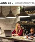 Woman and child reading under pendant lights in kitchen, illustrating An A19 LED Bulb 75W Equivalent 1100 Lumens 3500K Natural White Dimmable Energy Star Enclosed Fixture Rated E26 Medium Base Indoor And Outdoor 24 Pack Ideal For Ceiling Fans Lamps Chandeliers And Outdoor Fixtures.