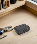 Three Piece Compact Dark Hardshell Toolbox Set Featuring Heavy Duty Waterproof Design For Engineers And Mechanics on wooden workbench