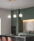 Antique Delicate Glass Pendant Light With Decorative Pattern over kitchen island, brass hardwired, adjustable ceiling fixture