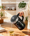 Person pouring hot water from Electric Tea Kettle With Temperature Control And Glass Body For Tea And Coffee Daily Driver.