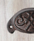 Solid As A Rock Brass Retro Drawer Pull Knockout Vintage Cast Iron Cabinet Knob detailed view on wood background.