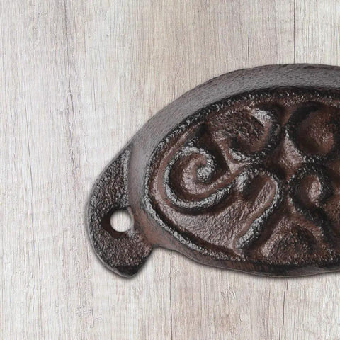 Solid As A Rock Brass Retro Drawer Pull Knockout Vintage Cast Iron Cabinet Knob detailed view on wood background.