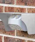 Tough As Nails Stainless Steel Doorbell Cover Plus Weatherproof Electrical Outlet Protector Shield Box For EV Charging Stations mounted on a brick wall.
