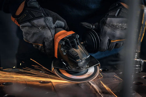 Top Shelf 1400 Watt Angle Grinder Packs Knock Tough 125mm Cutting Muscle in use with sparks flying during metal grinding.