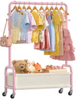 Heavy Duty Toddler Clothes Rack Featuring Open Storage Shelf Ideal For Kids Dress Up Costumes with pink frame and toys.