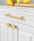 10 Pack Brushed Gold Cabinet Pulls With 5 Inch Hole Centers For Kitchen Cabinets And Bathroom Drawers on a white cabinet.