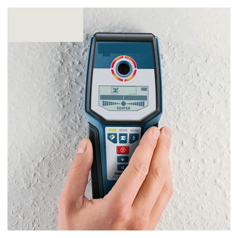 Heavy Duty Stud Finder Wall Scanner With Hella Precise Targeting For Locating Wood Studs Copper Wiring And Steel Rebar In Drywall Or Concrete Walls Offering Comfort Grip Design And Zero Guesswork For Weekend Warriors, hand-held on wall.
