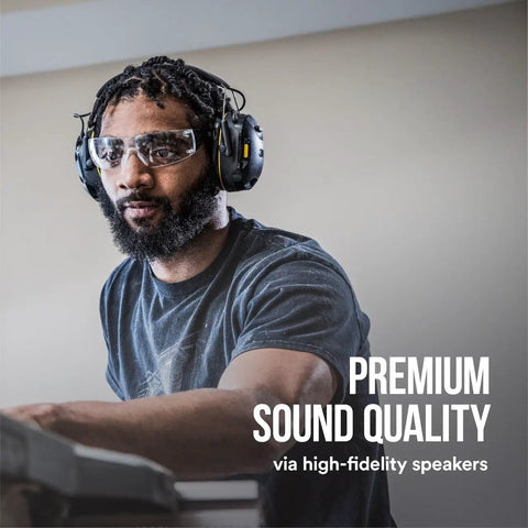 Individual wearing WorkTunes Connect Wireless Hearing Protector With Bluetooth Technology 26 DB Noise Reduction Rating Dope Sound Quality And Safe Volume Control for on-job listening