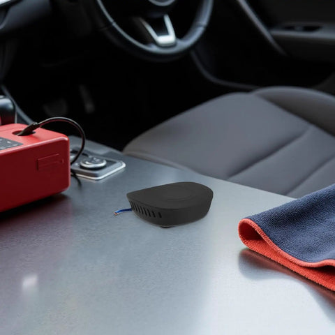 Self Activating Aerosol Car Fire Extinguisher Heat Triggered Auto Engine Bay Suppression Gear on car dashboard with red device.