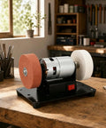 Badass Compact Bench Grinder With Dual Wheel Grit Setup Sleek Steel Body Heavy Duty Motor Housing Quick Swap Stones Shop Ready No Drama Finish For Real Jobs on workbench with tools and natural lighting.