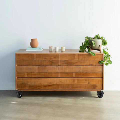 Wooden dresser on casters with a plant on top, featuring Three Inch Plate Caster Wheel Set With Cast Iron Swivel Plate Casters And Dual Locking.