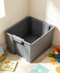 Medium Open Top Stackable Plastic Storage Bin With Reinforced Carry Handles Heavy Duty Gray Utility Tote Built Damn Tough For maximum home and garage organization needs in a corner with toys.