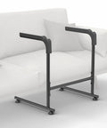 Heavy Duty Toilet Safety Rails With Padded Grip Handles Great For Seniors And Post Surgery Recovery To Help You Rise From Chair Or Couch Easily, black steel frame beside a couch.