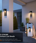Two Pack Modern Outdoor Wall Sconces Delivering Smooth 3000K Warm White Glow Plus Rock Solid IP65 Waterproof Aluminum Construction That Goes Tough For Porch Patio Front Door Or Garage Hardwired Exterior Lighting Fixtures Matte Black on wall with lush greenery.