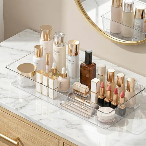 4 Pack 15x6 Inch Extra Large Clear Plastic Drawer Organizer Trays holding makeup items on a vanity.