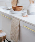 Top Shelf Six Pack Solid Brass T Bar Cabinet Pulls Hella Durable Gold Hardware For Kitchens And Dressers Clean Hammered Polish With Five Inch Center Spacing on white cabinets.