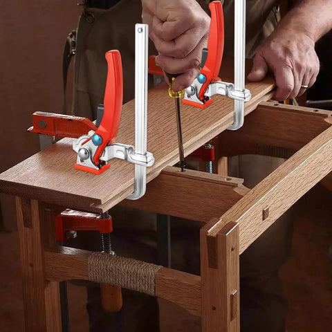 Two Pack Ratcheting Table Clamps With Quick Bar For Easy Grip, 0 To 6 Inch Clamping Range, Beefy Heavy Duty F Clamp For MFT Tables And Guide Rail Systems, 353 Lb Grip, Alloy Steel Track Saw Clamp Set securing wooden board on table.