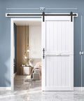 Slick White Barn Door With Solid Wood Core And Waterproof Vinyl Panel Including H Frame Sliding Hardware Kit Plus Handle installed in a modern interior.