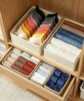 Kick Clutter To The Curb With This Slick Foldable Drawer Organizer Set Of Six Beige Fabric Compartments with bras and rolled clothes.