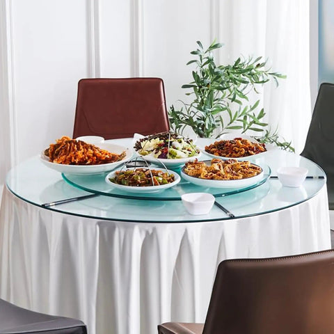 Big Boy Sized Round Lazy Susan With Dead Silent Glide 360 Degree Rotation Serving Tray Built From Bumper Glass And Heavy Duty Aluminum Base serving various dishes on a dining table.