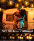Couple under Outdoor String Lights With Remote Control 75 Ft Waterproof Patio Lighting Kit creating a cozy lit vibe by a camper