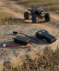 Powerful Electric Winch With Smart Rc Controller For Trail Crawlers featuring controller and receiver on a rock outdoors.