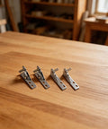 Four adjustable center column refrigerator door hinges with left shaft 0.28 inch diameter, zinc alloy, on wooden surface