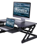 32 Inch Height Adjustable Standing Desk Converter With Slide Out Keyboard Tray and Dual Monitor Riser in black, featuring laptops on riser.