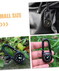 Two Pack Outdoor Hiking Compass With Carabiner Keychain on backpack, black compass in hand and on rock trail.