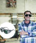 Top Shelf Welding Safety Goggles With Heavy Duty ABS Construction And Double Layer Lenses in use by a smiling man in a workshop.