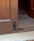Heavy Duty Spring Loaded Drop Rod Gate Latch Floor Mounted Hardware For Wood And Metal Doors, installed on a wooden door.