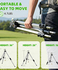 Person carrying Heavy Duty Brass Impact Tripod Sprinkler With Pulsating Water And Telescoping Legs Delivers 360 Degree Coverage Up To 70 Feet Reaching 5660 Square Feet Perfect For Yard Lawn Garden Irrigation 16 26 Or 36 Inch Heights.