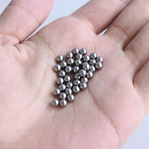 50 Pack 304 Stainless Steel Precision Ball Bearings 4mm displayed in a hand, showing smooth surface and silver finish.