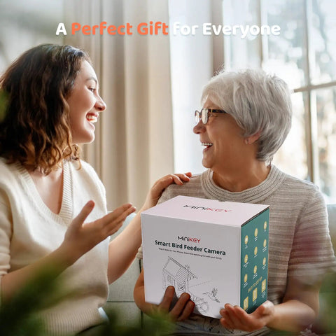 Two people smiling with a boxed Dope Bird Feeder With Camera Outdoor Birdhouse AI Identifies 11000 Species 3K HD Quality And Arrival Alerts
