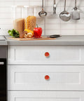 Top Shelf Red Happiness Round Cabinet Knobs Featuring A Slick Vintage Oil Paint Finish Hella Sturdy Rust Resistant Zinc Alloy Drawer Pulls Single Hole Mount Center Pack Of Four For Kitchen And Bedroom Cabinets on a white kitchen drawer.