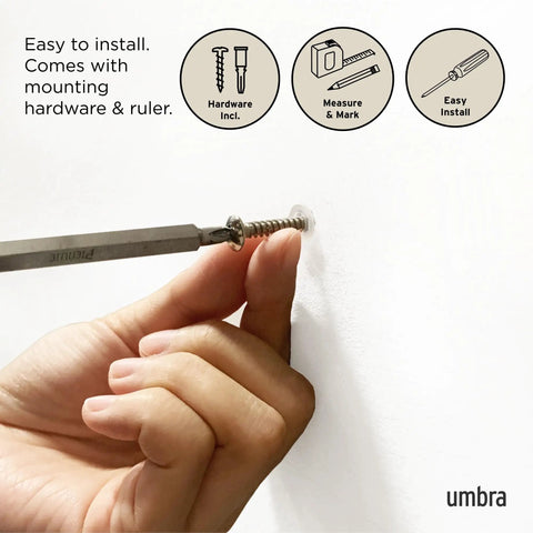 Hand installing Flip Wall Mounted Coat Rack With Retractable Hooks on wall using screw; easy installation hardware included