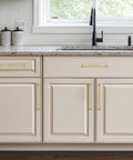 Top Shelf Brushed Gold Cabinet Handles Solid Zinc Alloy 7 1/2 Inch Center To Center 5 Pack installed on modern kitchen cabinets.