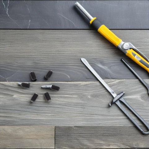 Rock Solid M4x6 Stainless Steel Ball Point Spring Plunger Set Screws 50 Pieces on a workshop table with tools.