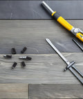 Rock Solid Spring Loaded Ball Plunger Set Screws M4x6 Hex Socket Cup Points 50 Pack with tools on wooden surface.
