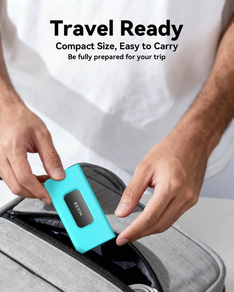 Person placing a turquoise 256GB External SSD Drive USB 3.1 Type C Portable Solid State Drive Up To 500MB/s into a bag.