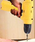 No Sweat Cordless Drill Set With Cushioned Anti Slip Handle drilling into wood, featuring yellow and black design, ergonomic grip.