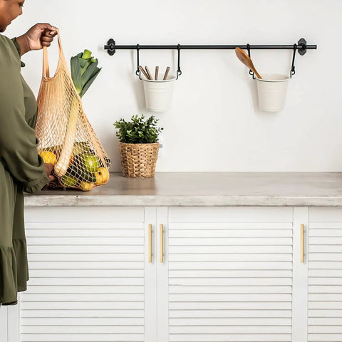 Top Shelf Champagne Gold Square Cabinet Handles For Modern Kitchen Drawers Hella Strong Heavy Duty Metal Construction With Ultra Smooth Finish And Quick Install 4 Inch Spread with green vegetables in a net bag.
