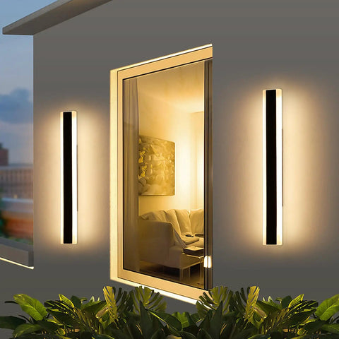 Slick Modern Outdoor Wall Lights 2 Pack Black Exterior Sconces featuring adjustable arms mounted beside a window.