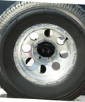 Close-up of tire secured with Replacement Tire Bolt And Hold Down Clamp For Car Wheels Durable Steel Retainer on a vehicle wheel.