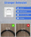 Clear heavy-duty outdoor string light clip with waterproof adhesive installed on a wood surface, demonstrating strong adhesion.